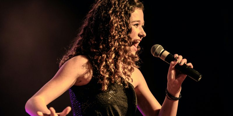 A woman embracing her vocal type when singing