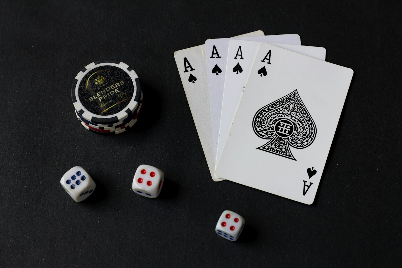 Close-up of dice and playing cards on a black table