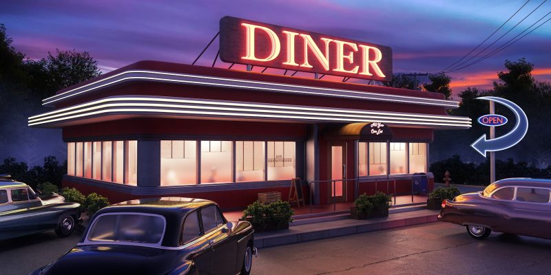 A classic American diner exterior at dusk with vintage cars parked outside