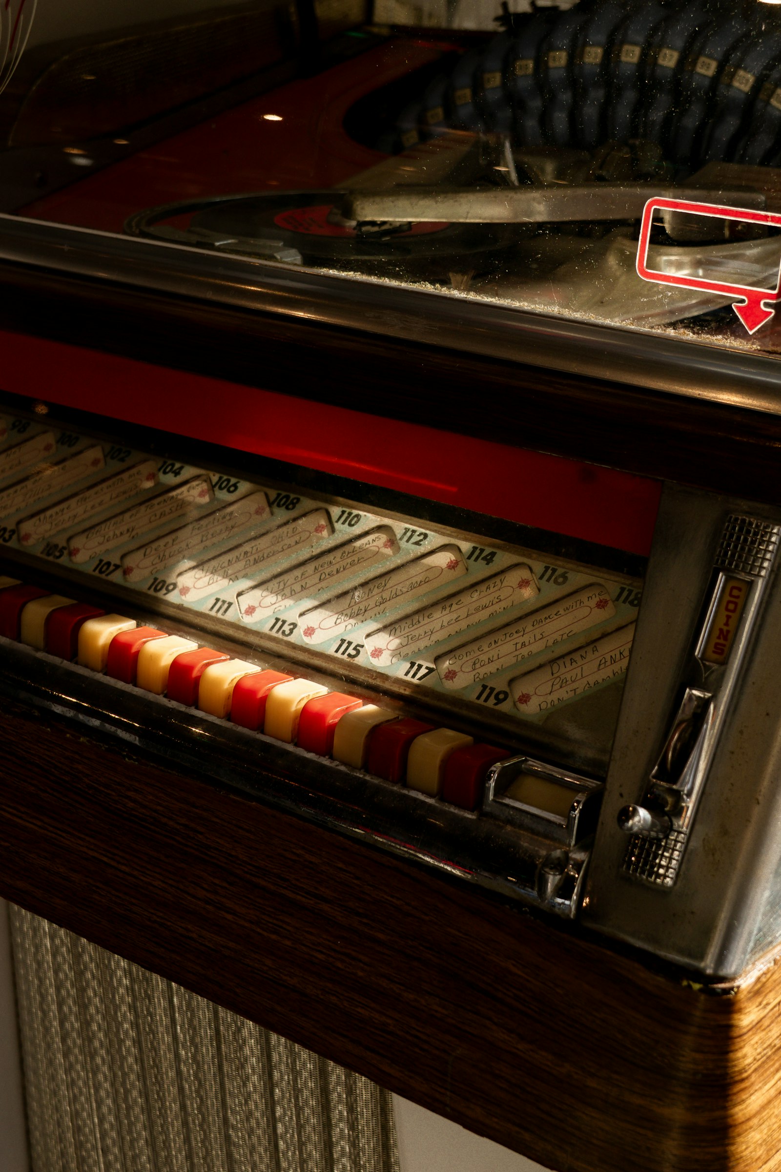 Close-up of a vintage jukebox with colourful song selection buttons