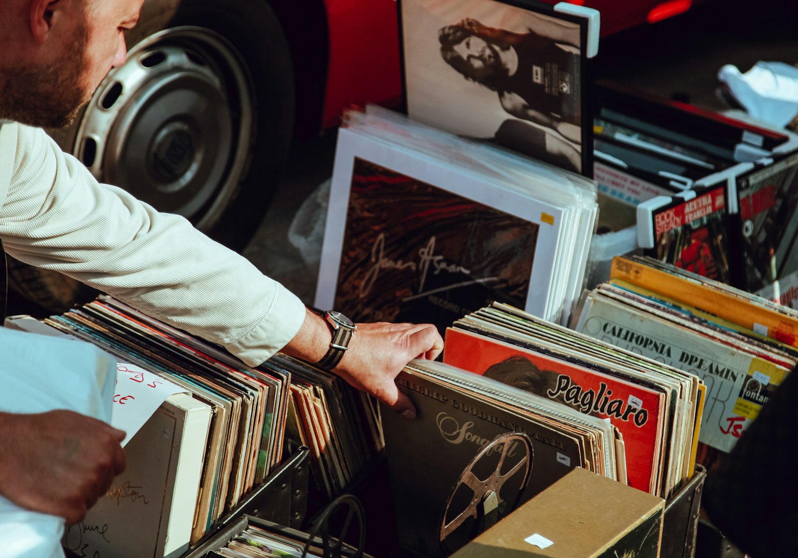 A person flicking through a crate of vinyl records